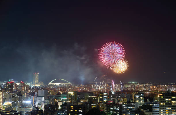 landscape of fukuoka city with fireworks